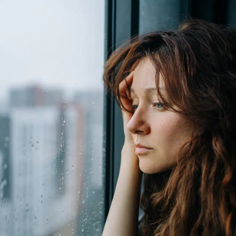 A woman looks our of a window