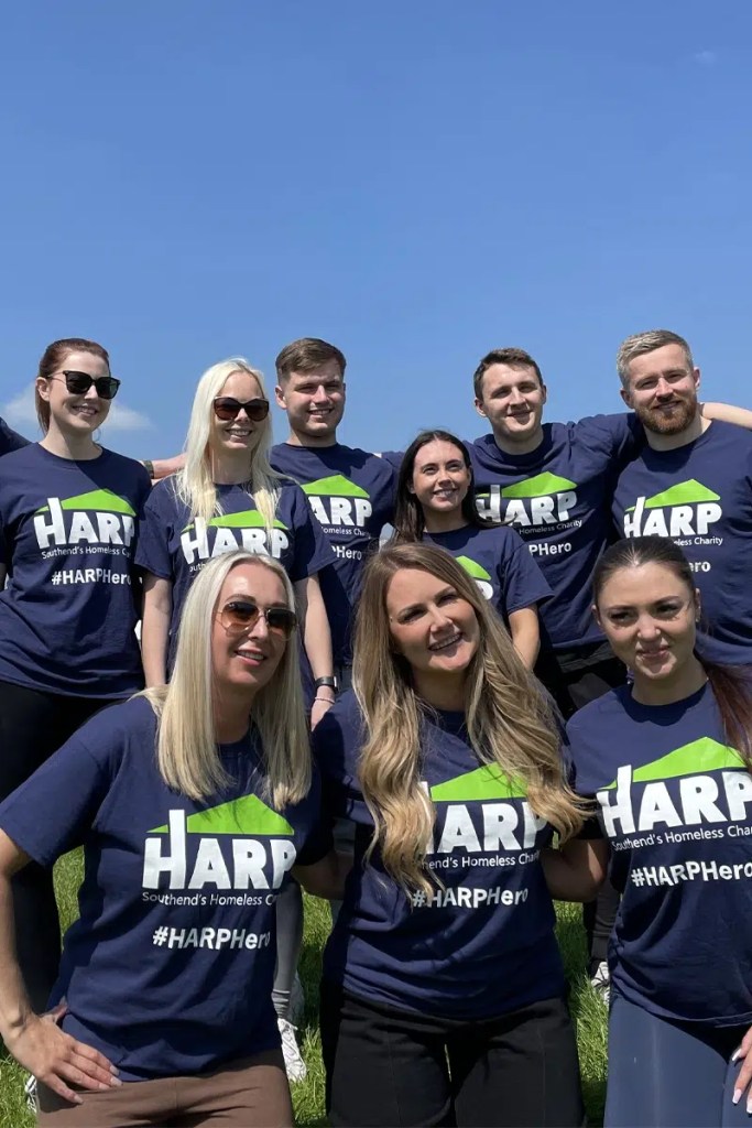 Eleven people work colleagues pose in the sunshine before undertaking a charity skydive